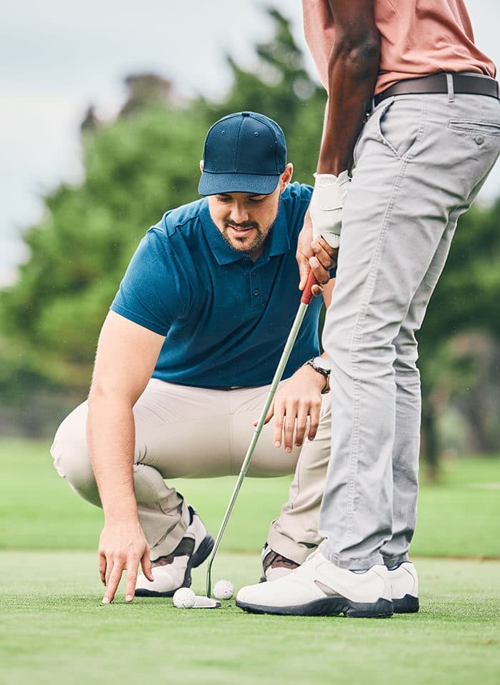 An instructor working through a swing on the range